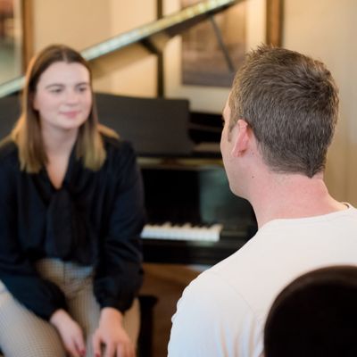 Capovario team member sitting with a female client in a music studio