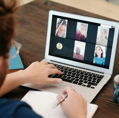 Man in video conference with processionals from other business firms